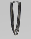 An edgy piece with a beautiful drape in 18k gold and blackened sterling silver box link chains. 18K goldBlackened sterling silverLength, about 18Toggle closureImported 