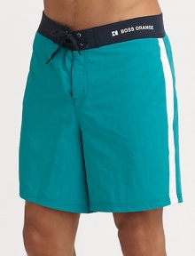 Catch some waves in this sporty pair with lace-up drawstring waistband, side stripe and logo detail.Lace-up drawstring waistbandInseam, about 7Polyester liningPolyamideMachine washImported Catch some waves in this sporty pair with lace-up drawstring waistband, side stripe and logo detail.Lace-up drawstring waistbandInseam, about 7Polyester liningPolyamideMachine washImported