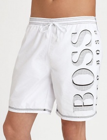 Hit the beach in authentic style in a solid pair with contrast stitching and large BOSS logo.Elastic drawstring waistbandSide slash pocketsInseam, about 7Polyester liningPolyamideMachine washImported Hit the beach in authentic style in a solid pair with contrast stitching and large BOSS logo.Elastic drawstring waistbandSide slash pocketsInseam, about 7Polyester liningPolyamideMachine washImported
