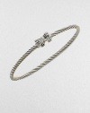 A charming, sterling silver cable design with a pretty diamond accented bow. Sterling silverDiamonds, .02 tcwDiameter, about 2½Slip-on styleImported 