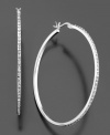 These slender hoops add the perfect touch of subtle glamour to your look. Featuring diamond accents set in sterling silver. Approximate diameter: 1-3/4 inches.