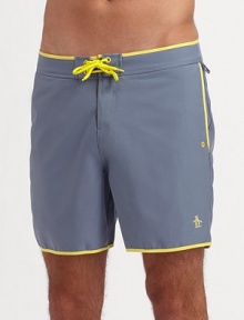 An easy-fitting swim favorite with a solid color and contrast trim in quick-dry nylon. Drawstring waist Side slash, back patch pockets Mesh lining Inseam, about 6 Polyester Machine wash Imported An easy-fitting swim favorite with a solid color and contrast trim in quick-dry nylon. Drawstring waist Side slash, back patch pockets Mesh lining Inseam, about 6 Polyester Machine wash Imported