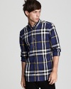 Burberry's essential button-down rendered in a rich check pattern and slim fit.