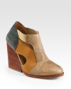 A chunky, stacked heel lifts this design of paneled leather and suede, topped with peek-a-boo cutouts. Stacked heel, 4 (100mm)Leather and suede upper with elasticized strapsPull-on styleLeather lining and solePadded insoleImported