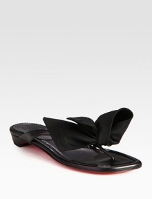 Classic Italian leather thong adorned by an unexpected, oversized nylon bow. Leather and nylon upperLeather liningSignature red leather solePadded insoleMade in ItalyOUR FIT MODEL RECOMMENDS ordering one half size up as this style runs small. Classic Italian leather thong adorned by an unexpected, oversized nylon bow. Leather and nylon upperLeather liningSignature red leather solePadded insoleMade in ItalyOUR FIT MODEL RECOMMENDS ordering one half size up as this style runs small.
