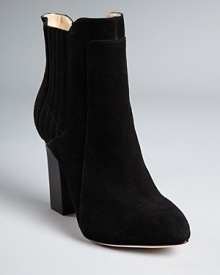 Forgoing typical elastic goring for a more sophisticated, suede-covered option, Joan & David reinvents the Chelsea boot, equipping it with a stacked heel. Forgoing typical elastic goring for a more sophisticated, suede-covered option, Joan & David reinvents the Chelsea boot, equipping it with a stacked heel.