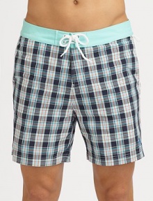 A quick-dry look with yarn-dyed checks revive a classic beach style. Drawstring waistBack flap pocketsMesh liningInseam, about 6PolyesterMachine washImported A quick-dry look with yarn-dyed checks revive a classic beach style. Drawstring waistBack flap pocketsMesh liningInseam, about 6PolyesterMachine washImported