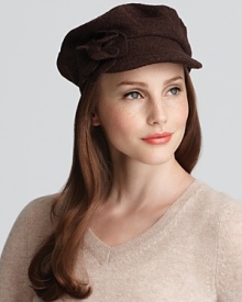 Add a chic update to your look with this flower embellished conductor hat from August Accessories. Add a chic update to your look with this flower embellished conductor hat from August Accessories.