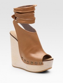 Chic, platform wedge style emboldened by a leather, wrap-around ankle strap. Wooden wedge, 5 Covered platform, 1½ Compares to a 2½ heel Leather upper Peep toe Leather lining Rubber sole Made in ItalyOUR FIT MODEL RECOMMENDS ordering one size up as this style runs small. Chic, platform wedge style emboldened by a leather, wrap-around ankle strap. Wooden wedge, 5 Covered platform, 1½ Compares to a 2½ heel Leather upper Peep toe Leather lining Rubber sole Made in ItalyOUR FIT MODEL RECOMMENDS ordering one size up as this style runs small.