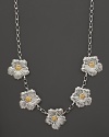 Delicate gardenias, captured at the height of their beauty in sterling silver and 18K yellow gold, bloom on this necklace from Buccellati.