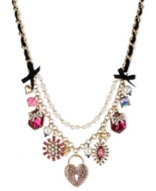 Betsey Johnson has the key to your heart. This frontal necklace flaunts heart lock charms with pink-colored crystal accents, fuchsia-colored crystal gems, glass pearls and faceted fuchsia bead. Finished with a black grosgrain ribbon, glass pearl chain and bubble hearts. Crafted in antiqued gold tone mixed metal. Approximate length: 16 inches + 3-inch extender. Approximate drop: 2-1/4 inches. Betsey Johnson has the key to your heart. This frontal necklace flaunts heart lock charms with pink-colored crystal accents, fuchsia-colored crystal gems, glass pearls and faceted fuchsia bead. Finished with a black grosgrain ribbon, glass pearl chain and bubble hearts. Crafted in antiqued gold tone mixed metal. Approximate length: 16 inches + 3-inch extender. Approximate drop: 2-1/4 inches.