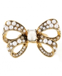 Bow-dacious! Made a bold style statement with this large-scale bow stretch ring from Betsey Johnson. Accented by glass pearls and sparkling clear crystals, it's made in gold tone mixed metal. Ring adjusts to fit finger. Bow-dacious! Made a bold style statement with this large-scale bow stretch ring from Betsey Johnson. Accented by glass pearls and sparkling clear crystals, it's made in gold tone mixed metal. Ring adjusts to fit finger.