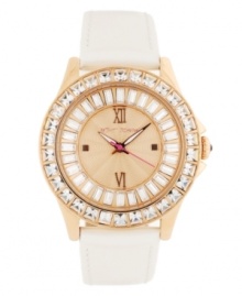 A new neutral for when you want to kick things into gear, by Betsey Johnson. Watch crafted of beige leather strap and round rose-gold tone stainless steel case. Bezel embellished with crystal accents. Textured rose-gold tone dial features ring of baguette-cut crystal accents, applied rose-gold tone Roman numerals at twelve and six o'clock, dot markers at three and nine o'clock, luminous hour and minute hands, signature fuchsia second hand and logo at twelve o'clock. Quartz movement. Water resistant to 30 meters. Two-year limited warranty. A new neutral for when you want to kick things into gear, by Betsey Johnson. Watch crafted of beige leather strap and round rose-gold tone stainless steel case. Bezel embellished with crystal accents. Textured rose-gold tone dial features ring of baguette-cut crystal accents, applied rose-gold tone Roman numerals at twelve and six o'clock, dot markers at three and nine o'clock, luminous hour and minute hands, signature fuchsia second hand and logo at twelve o'clock. Quartz movement. Water resistant to 30 meters. Two-year limited warranty.