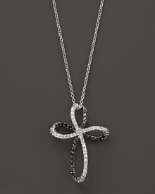 Black and white diamonds, set in 14K. white gold, form an elegant cross. Black and white diamonds, set in 14K. white gold, form an elegant cross.