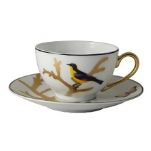 Embellished with a yellow-breasted songbird and a goldtone handle, this porcelain tea cup from Bernardaud brings an elegantly fanciful look to your table. Embellished with a yellow-breasted songbird and a goldtone handle, this porcelain tea cup from Bernardaud brings an elegantly fanciful look to your table.