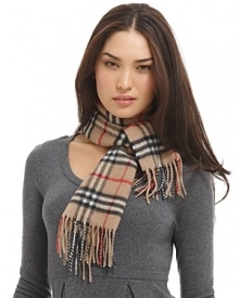Luxuriously soft cashmere scarf in an all over check pattern is finished with fringe trim. Luxuriously soft cashmere scarf in an all over check pattern is finished with fringe trim.