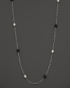 This sterling silver necklace, gleaming with blue tigers eye and freshwater pearls, makes an elegant statement. By Di MODOLO.