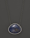 Diamonds circle a faceted rutilated quartz and blue sodalite doublet set in blackened sterling silver. By Di Massima.