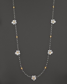 Delicate gardenias, captured at the height of their beauty in sterling silver and 18K yellow gold, bloom on this necklace from Buccellati.