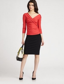 DVF's signature wrap effect adds a glam touch to this shiny, three-quarter-sleeved pullover.V-neckThree-quarter sleevesPullover styleAbout 21 from shoulder to hemViscose/LycraDry cleanImportedModel shown is 5'10 (177cm) wearing US size Small. DVF's signature wrap effect adds a glam touch to this shiny, three-quarter-sleeved pullover.V-neckThree-quarter sleevesPullover styleAbout 21 from shoulder to hemViscose/LycraDry cleanImportedModel shown is 5'10 (177cm) wearing US size Small.