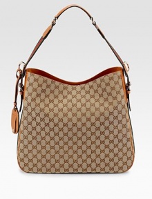 GG fabric with signature web detail, leather trim, and light goldtone hardware.Adjustable shoulder strap, 9¾ drop Tab snap closure Detachable identification tag with embossed vintage gucci trademark Inside zip, cell phone and PDA pockets Fully lined 15¾W X 13½H X 4D Made in Italy GG fabric with signature web detail, leather trim, and light goldtone hardware.Adjustable shoulder strap, 9¾ drop Tab snap closure Detachable identification tag with embossed vintage gucci trademark Inside zip, cell phone and PDA pockets Fully lined 15¾W X 13½H X 4D Made in Italy