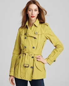 Lightly metallic, this compact Burberry Brit trench puts a spin on the iconic silhouette--equally timeless but updated with modern details. Lightly metallic, this compact Burberry Brit trench puts a spin on the iconic silhouette--equally timeless but updated with modern details.
