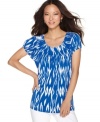 Go bold with Style&co.'s pleated top! Bright color and an on-trend ikat print freshen up this wardrobe staple.