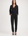 This silky, impeccably tailored one-piece is the epitome of minimal elegance.Surplice neckline with side notchesLong sleeves with underarm ventsBanded waist with belt loopsIncluded beltZip flyFront pleatsSide slash pocketsInseam, about 3351% acetate/49% viscoseDry cleanMade in USA of Italian fabricModel shown is 5'10 (177cm) wearing US size 4. 