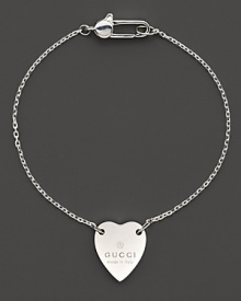 From the Trademark Collection, this sweet sterling silver bracelet features a woven chain with engraved logo heart charm. Designed by Gucci. From the Trademark Collection, this sweet sterling silver bracelet features a woven chain with engraved logo heart charm. Designed by Gucci.