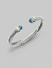 From the Silver Classics Collection. The signature Yurman cable bangle, capped with faceted blue topaz domes and accents of 14k gold. Blue topaz Sterling silver and 14k yellow gold Cable, 7mm Diameter, about 2¼ Imported From the Silver Classics Collection. The signature Yurman cable bangle, capped with faceted blue topaz domes and accents of 14k gold. Blue topaz Sterling silver and 14k yellow gold Cable, 7mm Diameter, about 2¼ Imported