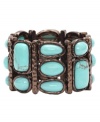 Shift into neutrals. Monet's stunning stretch bracelet combines a rich bronze tone mixed metal setting with bright reconstituted turquoise stones. Bracelet stretches to fit wrist. Approximate diameter: 2-1/4 inches.