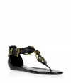 Warm up your style with these edgy sandals from celeb-favorite Parisian label Balmain - Thong style, front gold-tone buckle T-strap detail, two-buckle detail at ankle strap, back zip closure - Wear with a draped mini-dress, an oversized blazer, and oversized sunglasses for a summer-in-the-city look