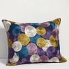 Printed with bold, swirling circles, this decorative pillow adds some color to any room.