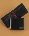 Colorful striping is a preppy touch on the inside of this versatile leather wallet from Tommy Hilfiger.