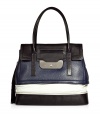 Chic handbag in supple, fashionably colorblocked leather - Bold and sophisticated in black, navy and white - Structured flap top silhouette with detachable tassel and zipper embellishments - Two top handles and silver metal turnlock closure - Outer zip compartment and protective metal feet - Lined in cotton, with one interior zip pocket and two open pockets - Seamlessly transitions from work to weekend