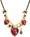 This style's perfect for you, wild thing! Betsey Johnson puts the fierce in fashionista with hot pink zebra-print hearts, black grosgrain ribbon, crystal-accented bows, a black and yellow flower, baguette crystals, an ivory and gold detailed monkey, and a black and yellow polka dot teardrop. Set in gold tone mixed metal. Approximate length: 16 inches + 3-inch extender. Approximate drop: 1-1/2 inches.