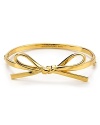 kate spade new york puts a rich spin on the girlish ribbon theme. This sweetly styled bangle is a chic reminder to be jeweled.