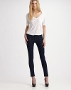 Dark wash in clingy stretch denim leggings.THE FITBody-hugging fit from waist to ankle Mid rise Inseam, about 31THE DETAILSZip fly Button waist with belt loops Front scoop pockets and patch coin pocket with rivets Back patch pockets Signature patch at waist 44% rayon/29% cotton/25% cupro/2% polyurethane Machine wash Made in USA of imported fabric