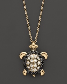 Black and white diamonds set in a 14K. yellow gold turtle pendant. Black and white diamonds set in a 14K. yellow gold turtle pendant.