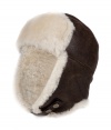 Both comfortable and stylish, UGG Australias shearling lined leather trapper cap is an ultra cozy cold weather must - Cream shearling lining, chocolate leather outside, logo snap strap - Wear with puffy parkas and matching shearling boots