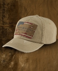 A classic baseball cap gets a downtown overhaul in faded and frayed cotton twill and features a rugged American flag patch for old-school appeal.