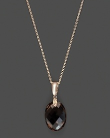 Diamonds accent a faceted smoky quartz, set in 14K rose gold. Diamonds accent a faceted smoky quartz, set in 14K rose gold.