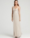 This wispy Amsale one-shoulder gown of rich silk hangs fluidly on the frame.