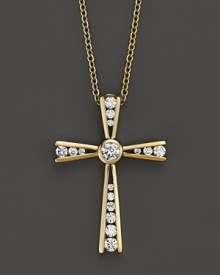 Diamonds set in a 14K yellow gold cross. Diamonds set in a 14K yellow gold cross.