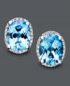 Like staring into two clear, blue pools. These bright earrings feature oval-cut blue topaz (4 ct. t.w.) and round-cut diamond (1/8 ct. t.w.). Crafted in 14k white gold. Approximate diameter: 1/2 inch.