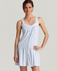 A sleeveless chemise with a lace pleated V-neckline and button front. A sleeveless chemise with a lace pleated V-neckline and button front.