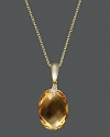 Diamonds accent a faceted citrine, set in 14K yellow gold.