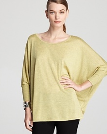 Make space in your fashion repertoire for this Eileen Fisher top, flaunting a fluid silhouette and dolman sleeves for easy elegance. Make space in your fashion repertoire for this Eileen Fisher top, flaunting a fluid silhouette and dolman sleeves for easy elegance.