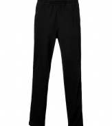Work out without compromising on style in Ralph Laurens super soft fleece track pants - Drawstring waistband with black tie, white side stripes, zippered front slit pockets, front seams, embroidered red polo player at thigh - Straight leg - Wear with your favorite hoodie and bright sneakers