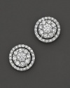 Diamond flower stud earrings framed in diamond pavé, set in 14 Kt. white gold.